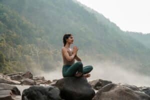 woman sitting on top of a rock